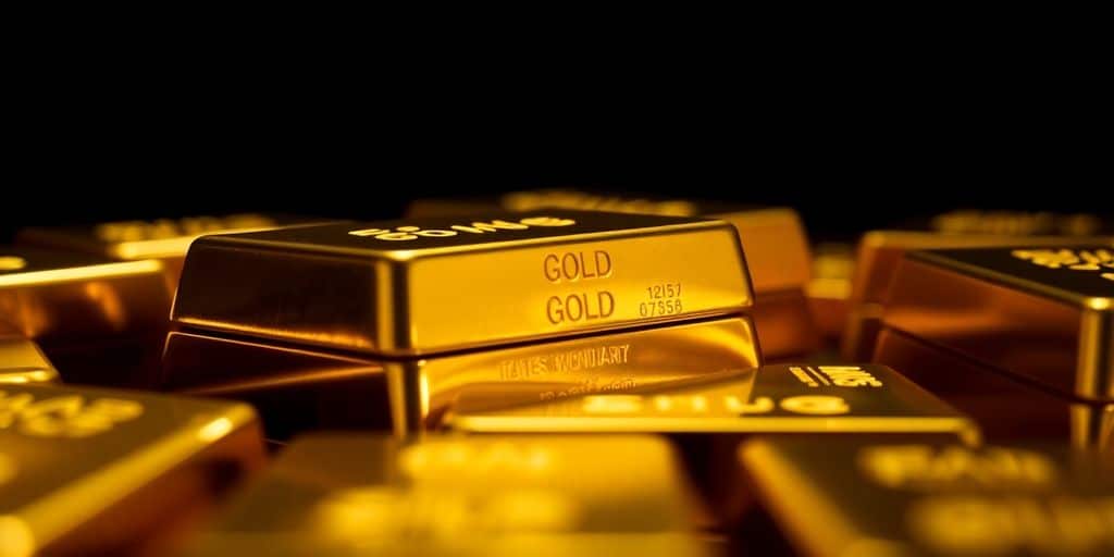 Des barres d'or brillantes sur un fond sombre.