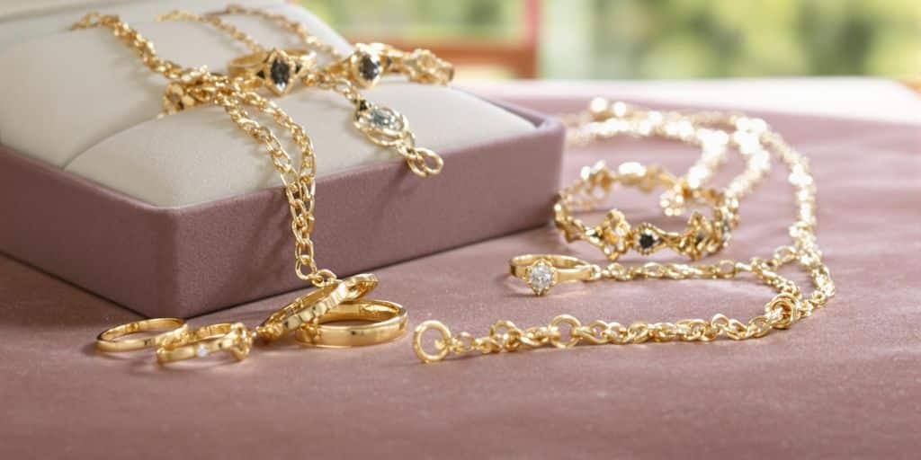 Bijoux en or posés sur un écrin en velours bleu.