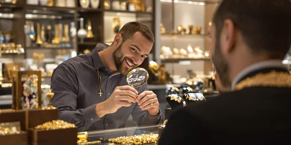 Bijoutier professionnel examine des bijoux en or avec un client