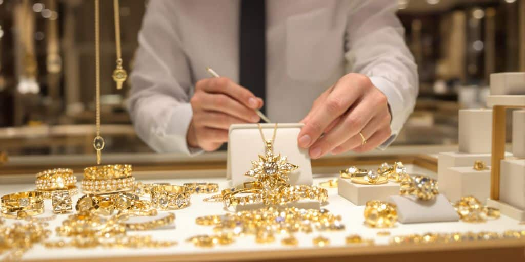 Bijoux en or examinés dans une boutique moderne par un expert.