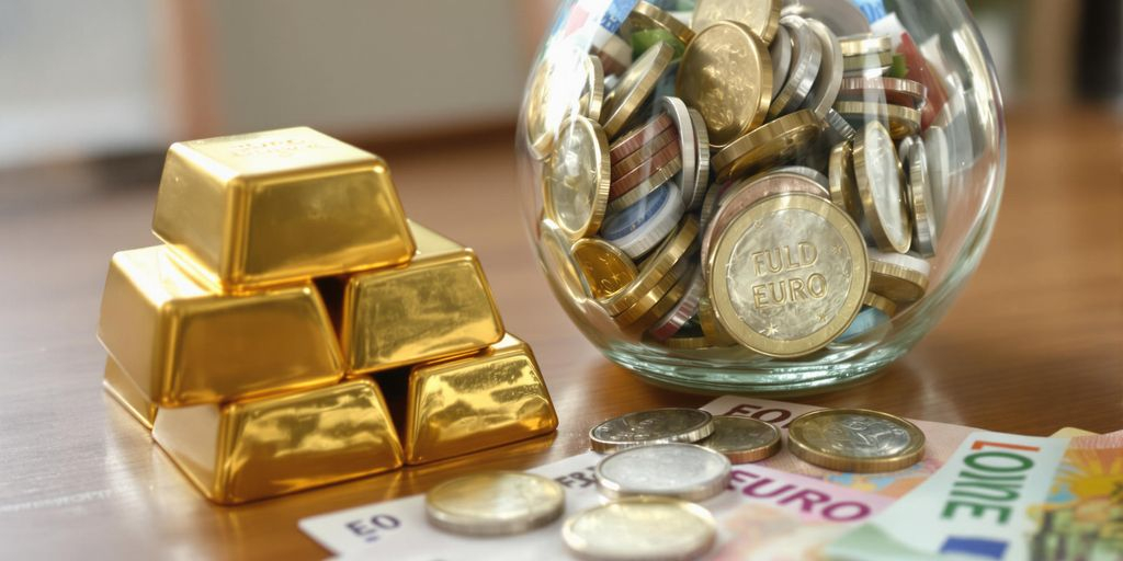 Lingots d’or posés près d’un bocal de pièces euros