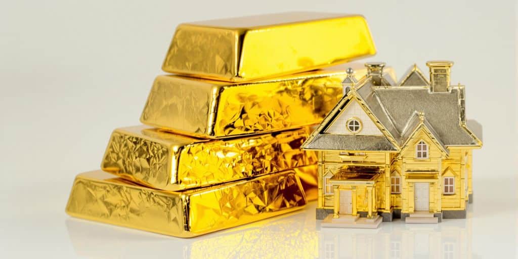 Lingot d'or et maison miniature
