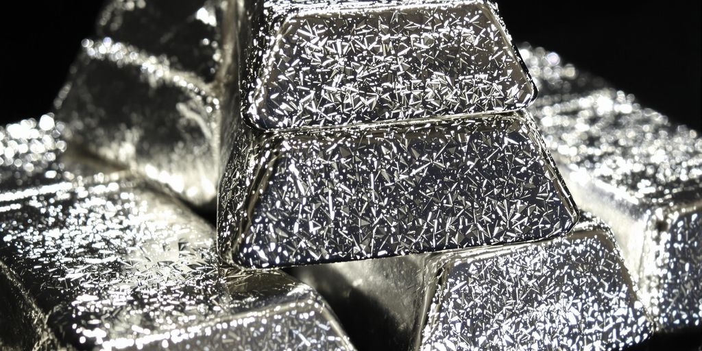 Lingots d'argent scintillants sur fond sombre.