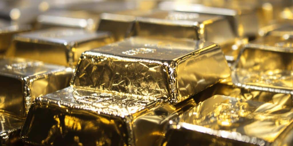 Lingots d'argent brillants sous une lumière dorée.
