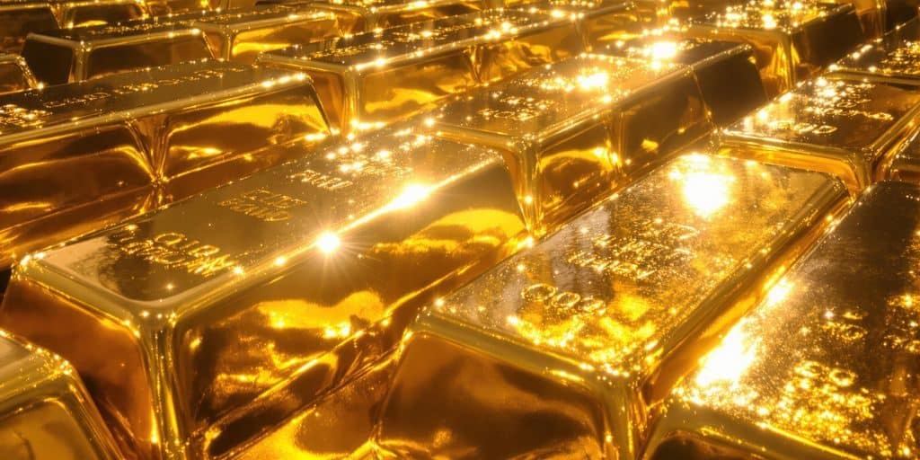 Lingots d'or sur un fond de carte du monde.