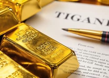 Lingots d'or et documents de succession sur une table.