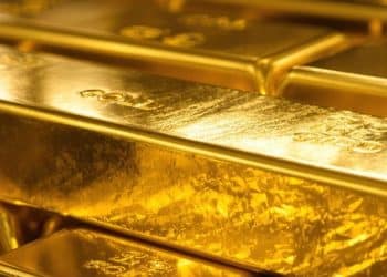 Lingots d'or brillants sur fond sombre.
