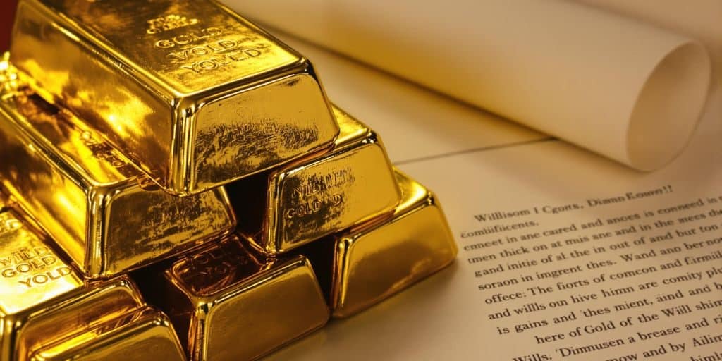 Lingots d'or et documents de succession sur un bureau.