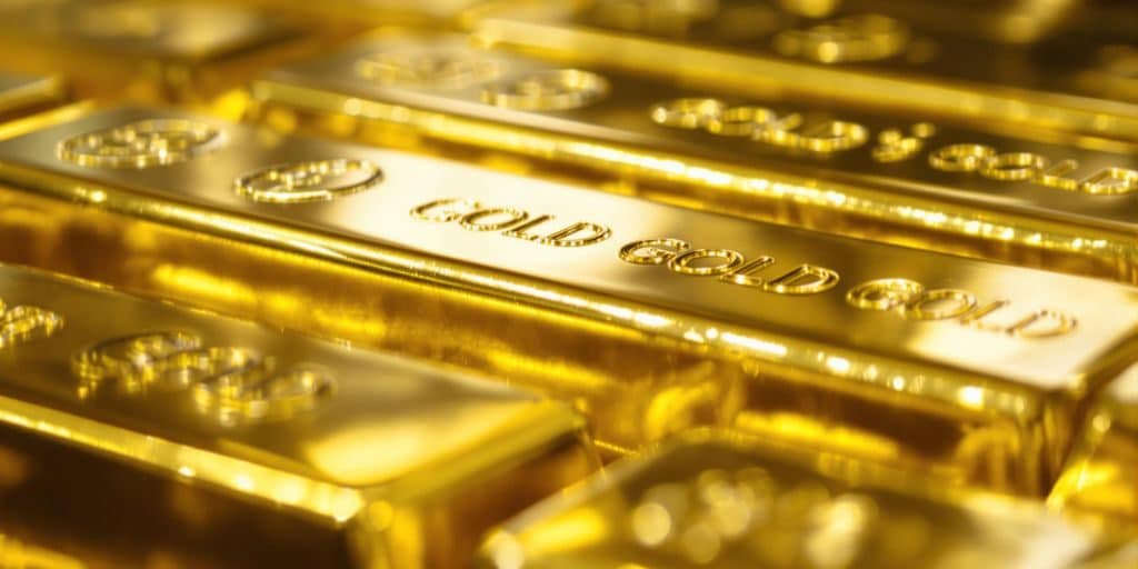 Lingots d'or brillants sur un fond sombre.
