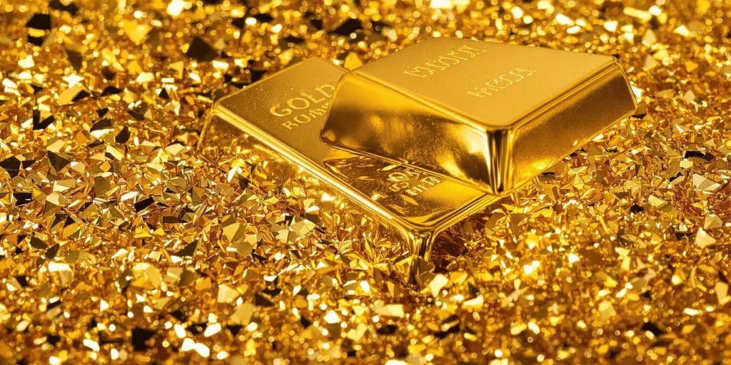 Lingots d'or brillants reposant sur des feuilles d'or.