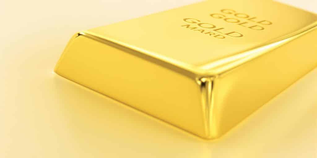Lingot d'or brillant sur fond neutre.