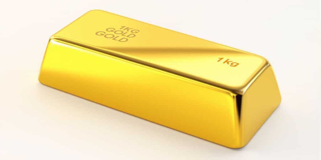 Un lingot d'or brillant sur un fond neutre.