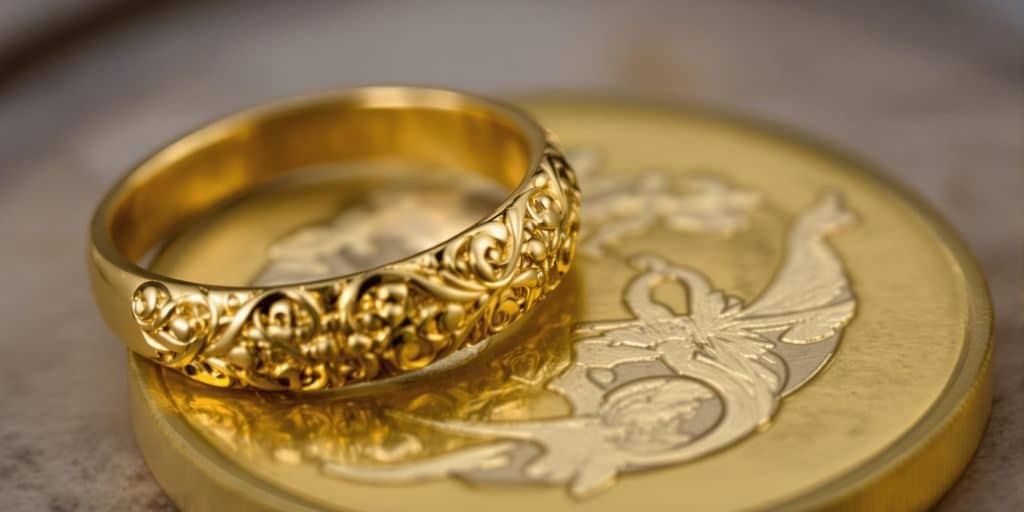 Louis d'or et bague en or côte à côte.